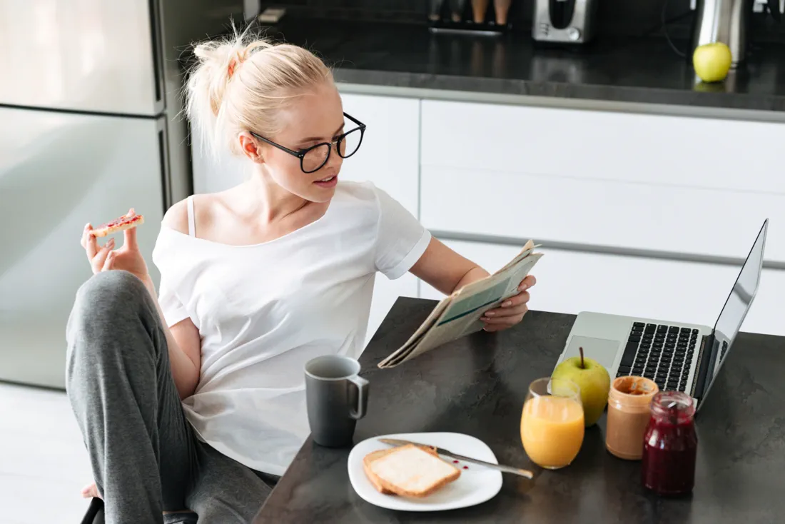 Person enjoying breakfast while planning their day
