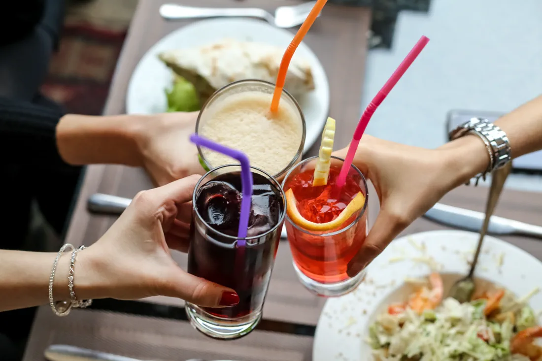 People sharing drinks and food at a Melbourne venue